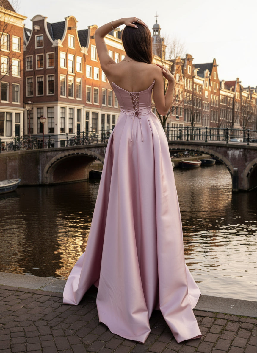 Woman wearing a pink satin gown in a minimalistic setting